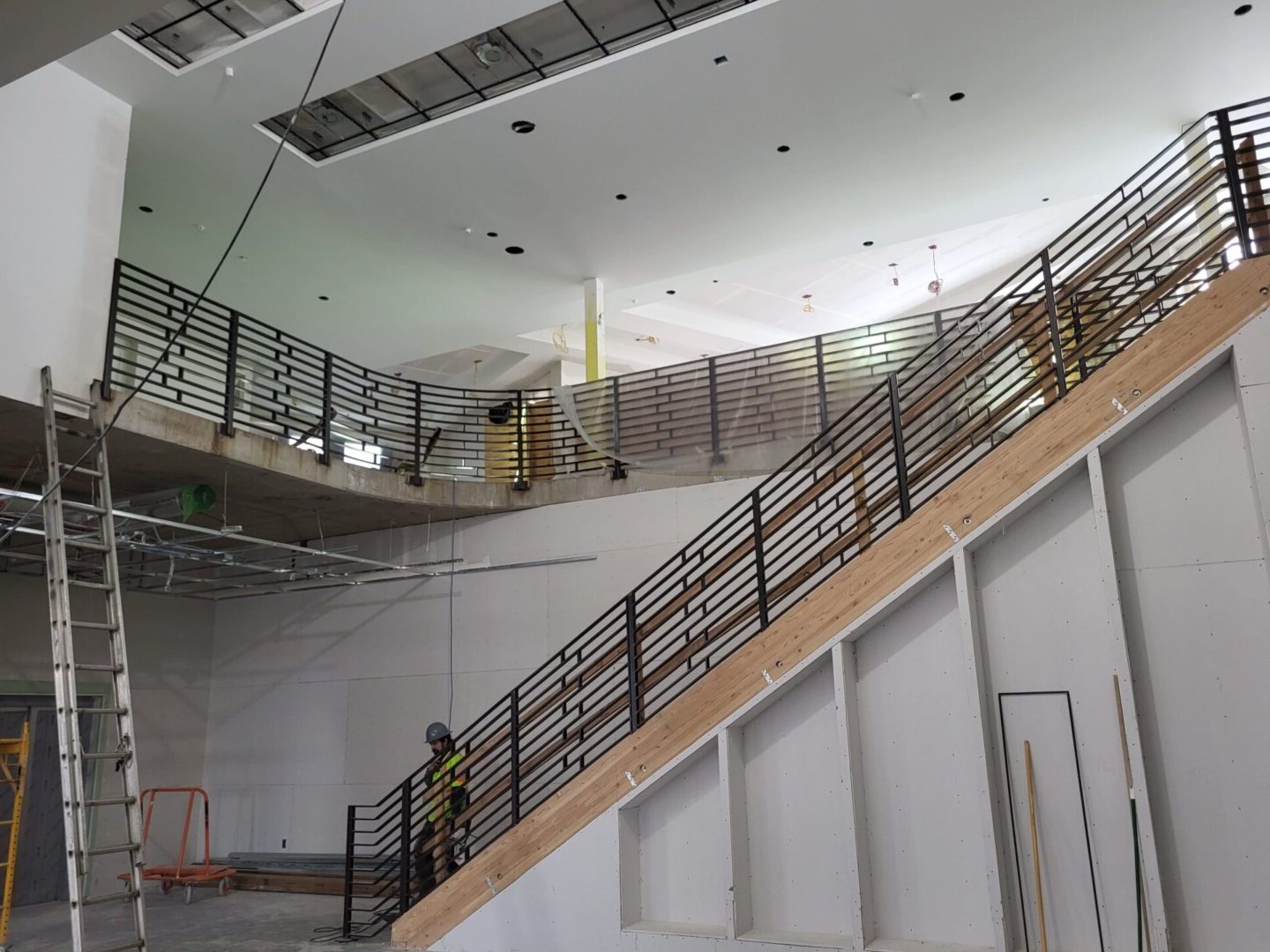 A staircase with metal railing and steps in the middle.