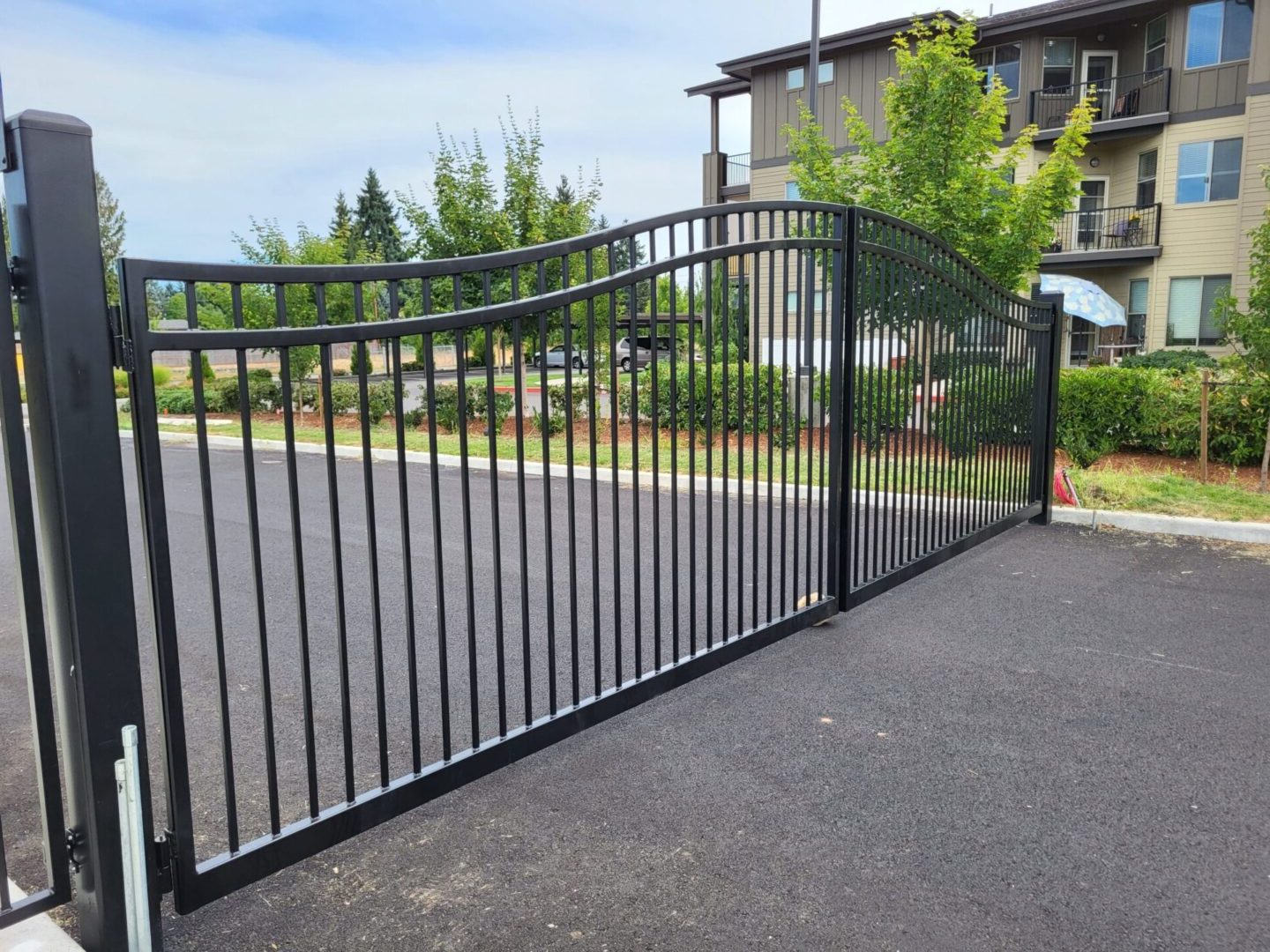 A driveway with a gate and fence in it