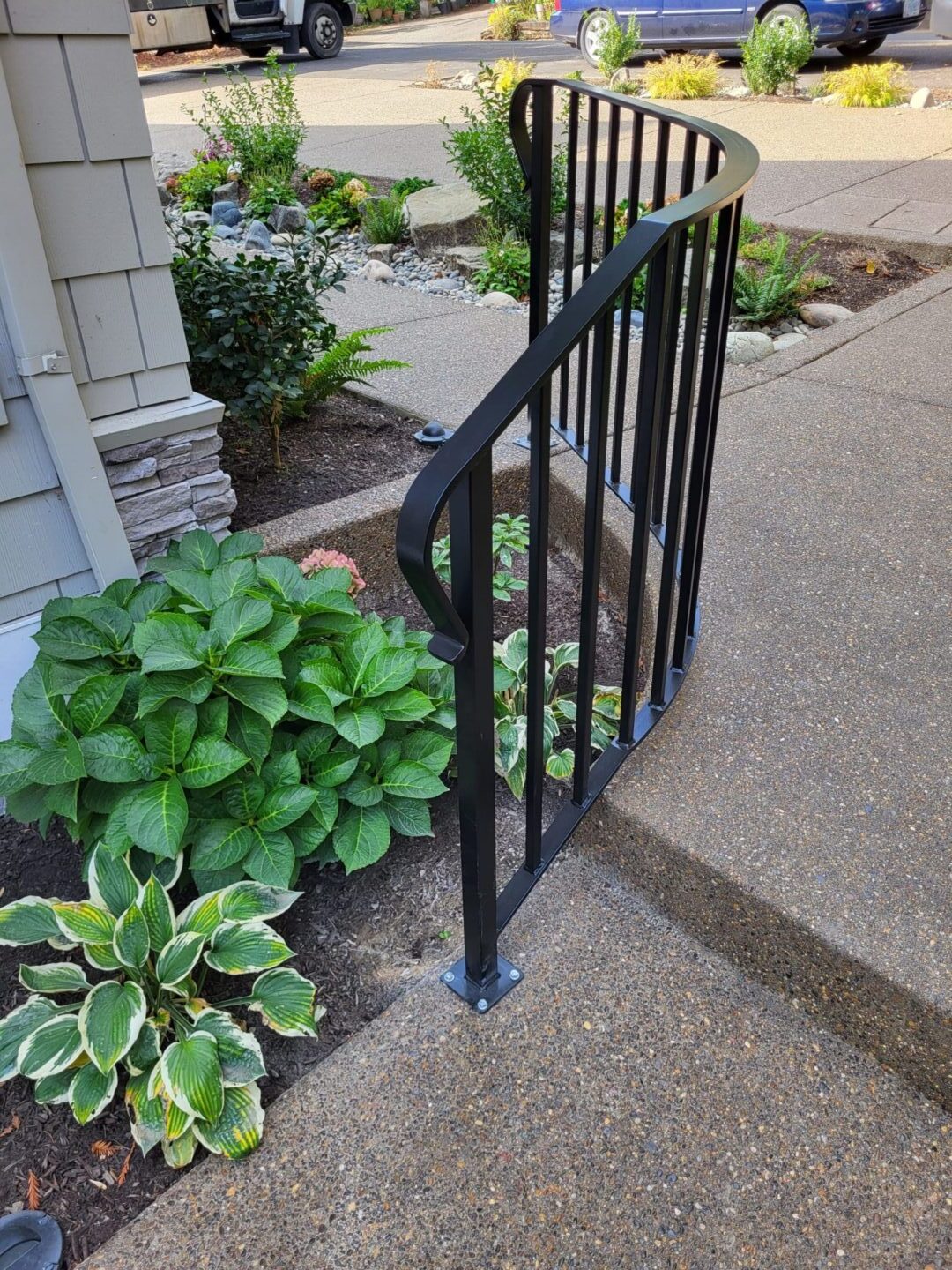 A black metal gate on the side of a house.
