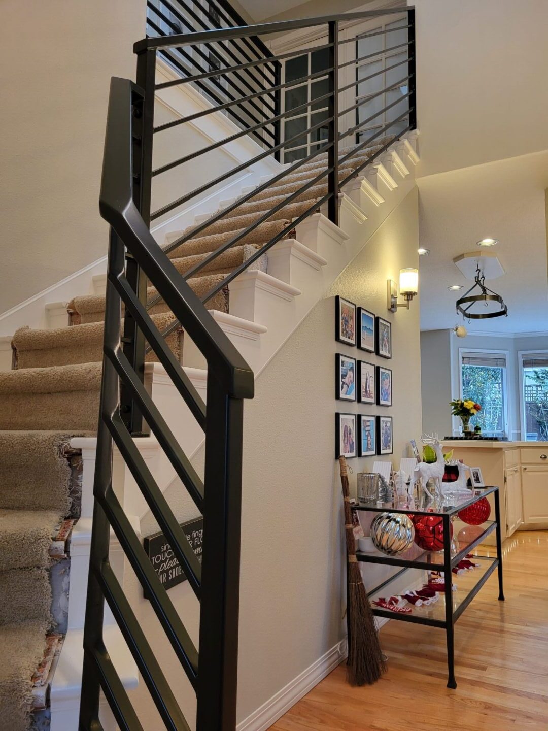A staircase with metal railing and white walls.