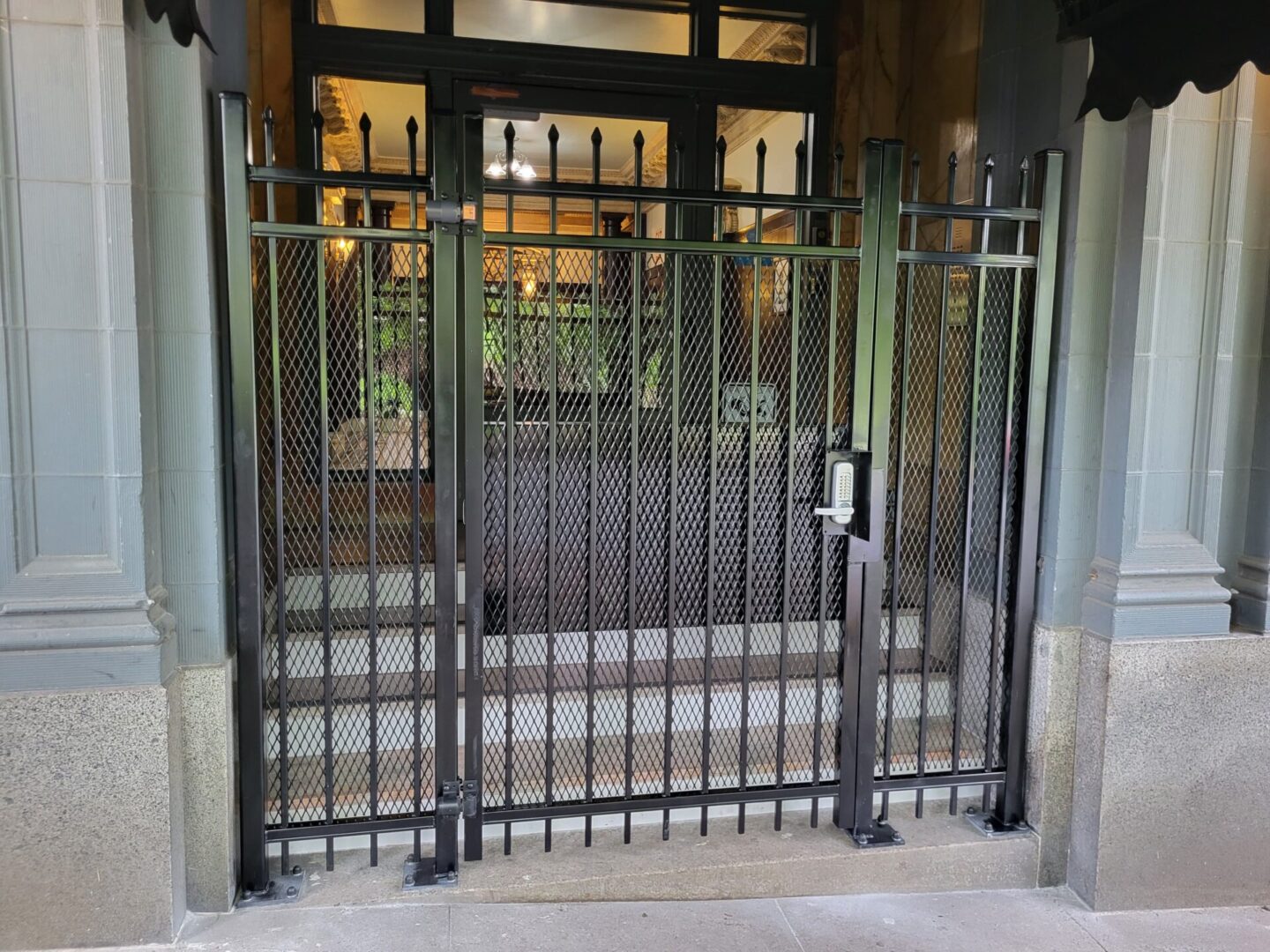 A metal gate with two sets of bars on each side.