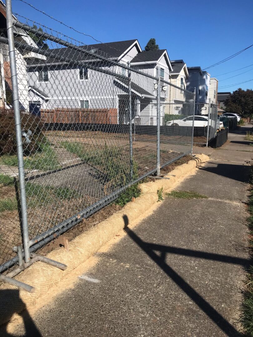 A fence that is in front of some houses.