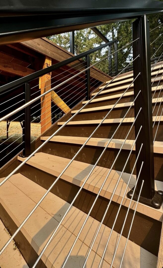 A wooden staircase with metal railing and wood steps.