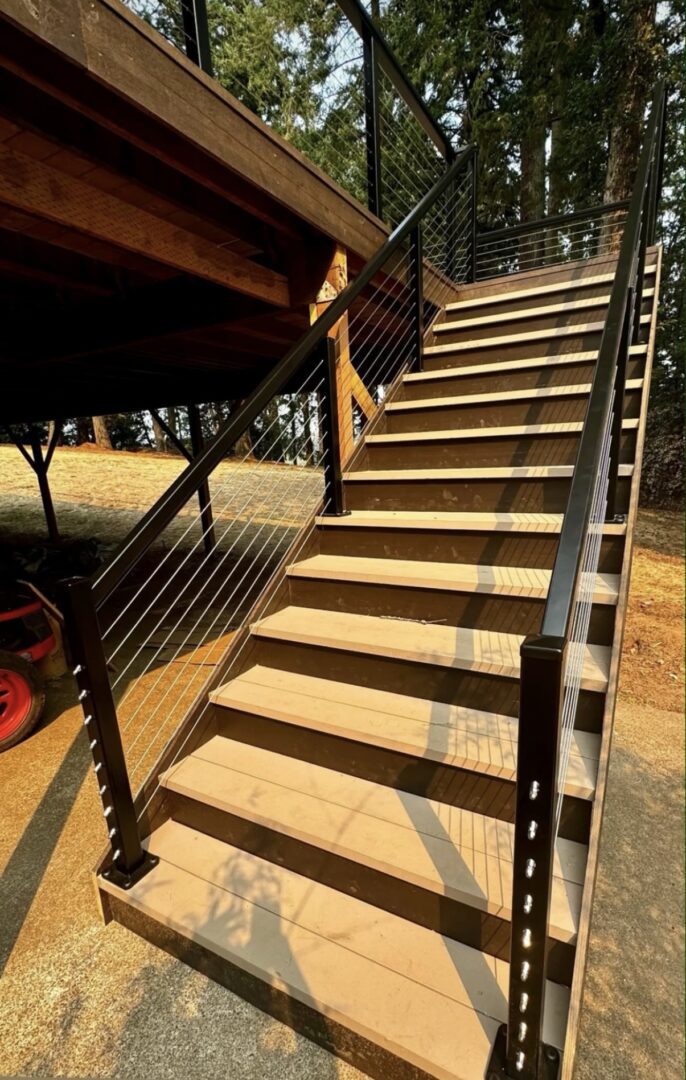 A wooden staircase with metal railing and wood steps.