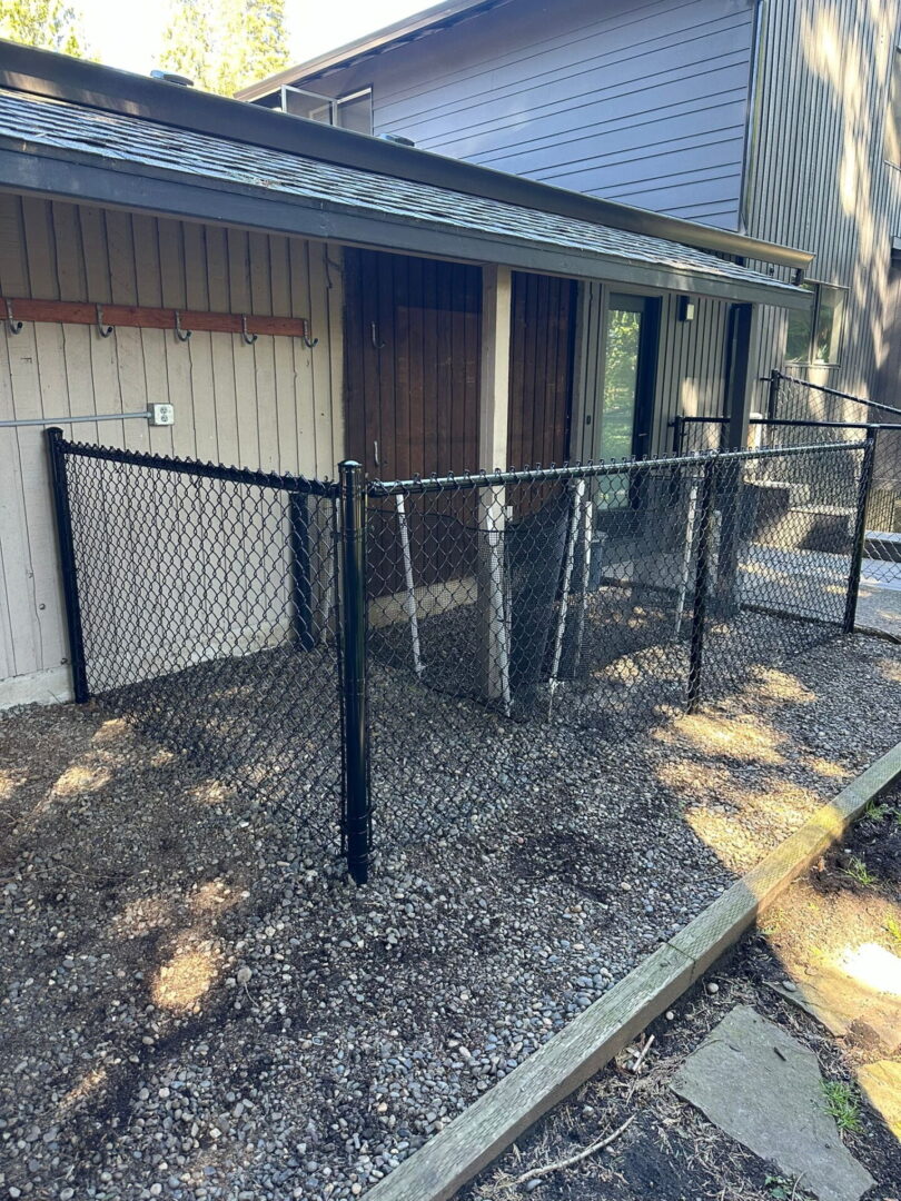 A fenced in area with a door and a fence.