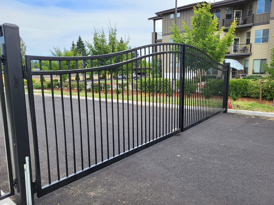 A driveway with a gate and fence in it