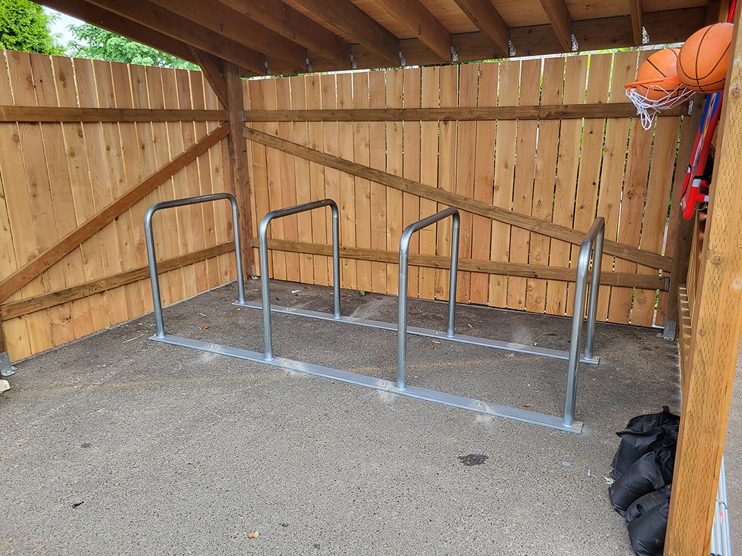 A bike rack in the middle of a parking lot.