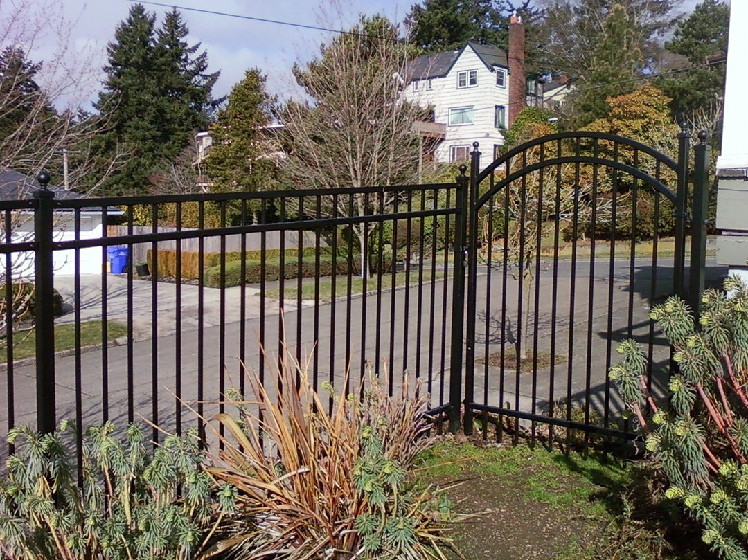 A gate that is open on the side of a road.