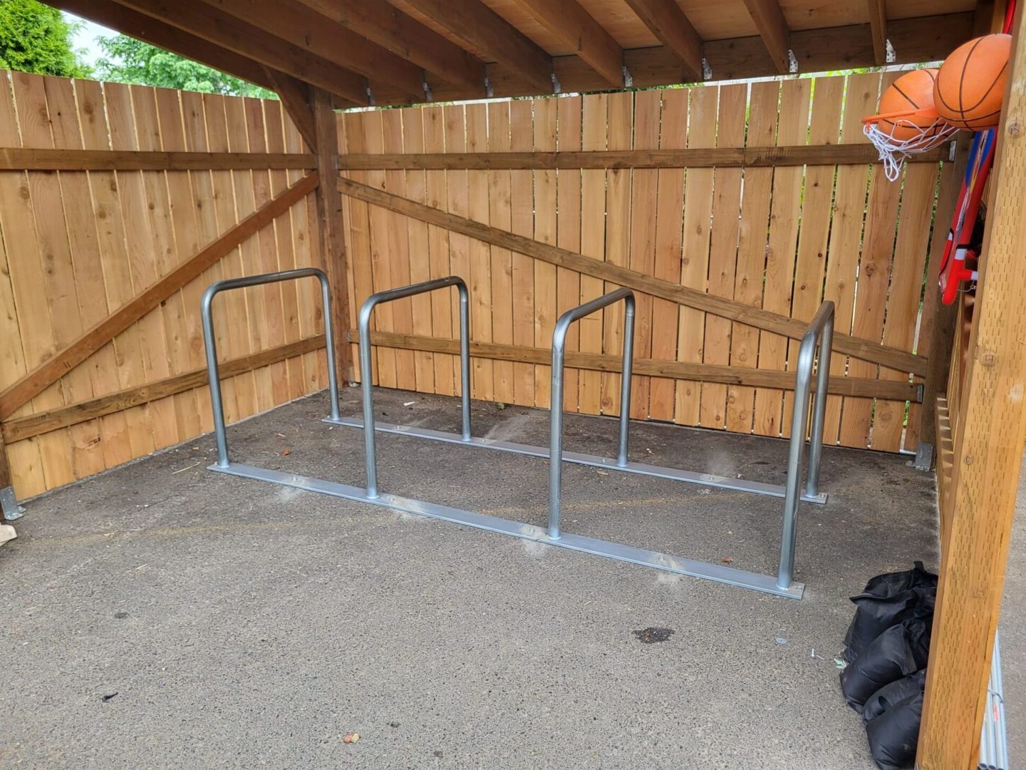 A bike rack in the middle of a parking lot.