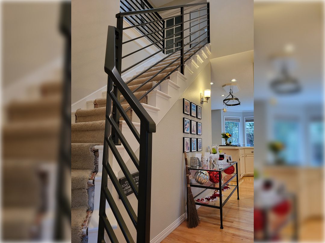 A staircase with metal railing and wooden steps.