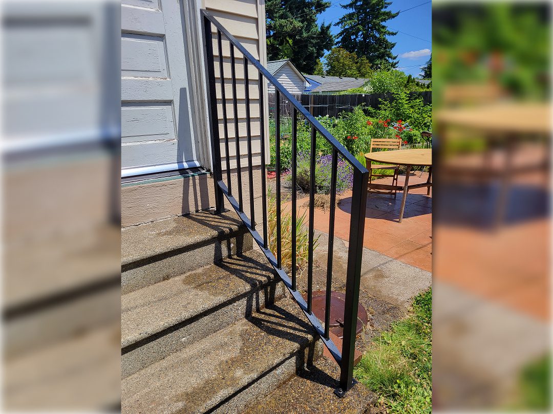 A metal railing on the side of steps.