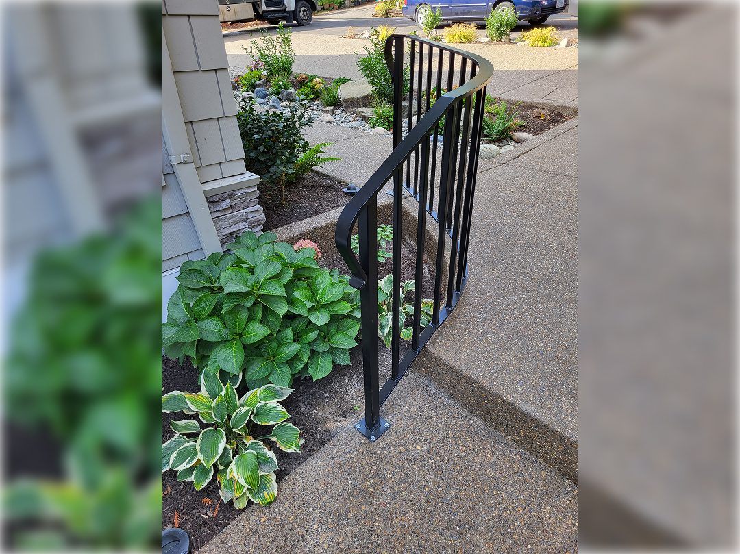A black metal railing on the side of a house.